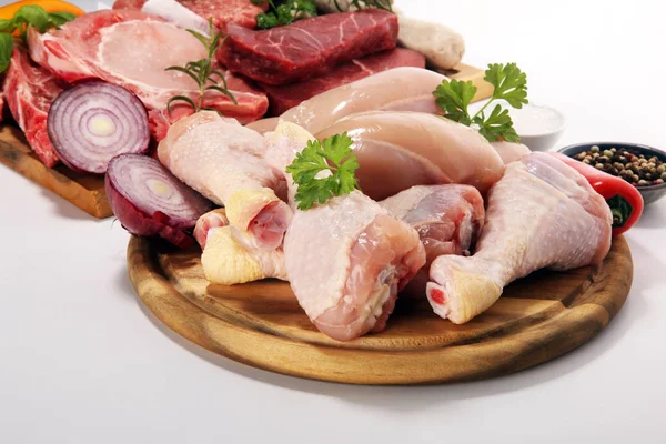 raw meat. Different types of raw pork meat, chicken and beef with spices and herbs and sausages