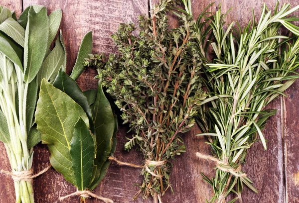 Homegrown and aromatic herbs on rustic background with rosemary — Stock Photo, Image