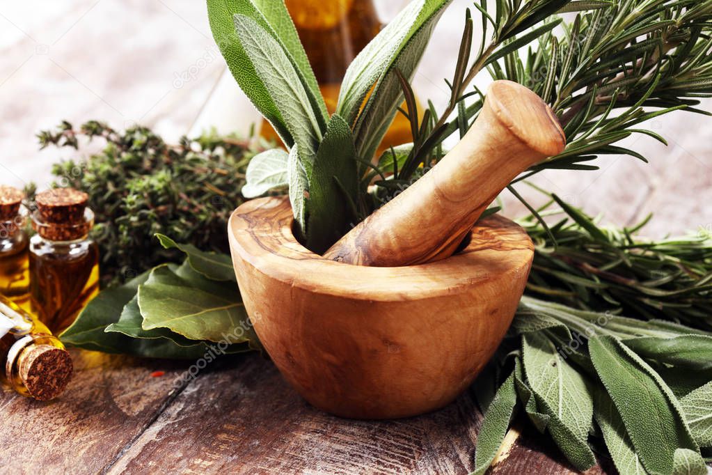 Fresh herbs from the garden and the different types of oils for 