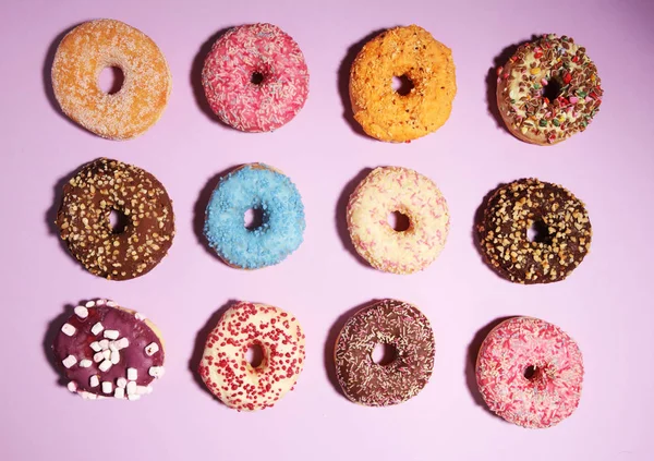 Assorted donuts with chocolate frosted, pink glazed and sprinkle — Stock Photo, Image