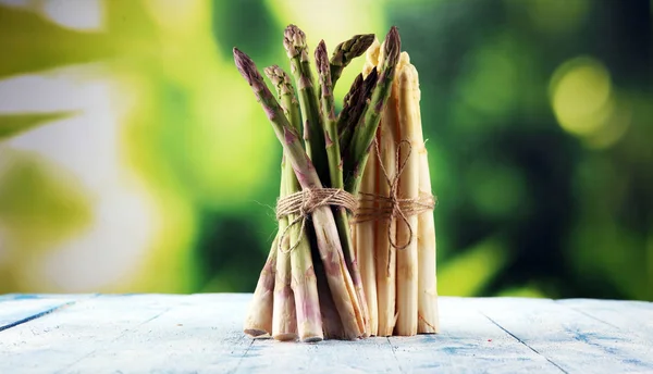 White and green asparagus on vintage old background.