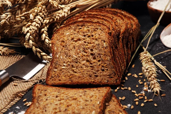 Bread on black board from above. Kitchen or bakery poster design — Stock Photo, Image