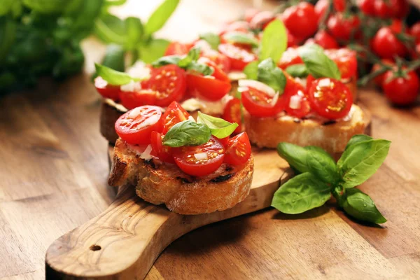 Traditional italian antipasto bruschetta appetizer with cherry t — Stock Photo, Image