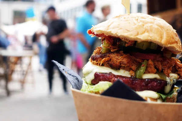 Organic Burger on street food festival. Pulled pork or burger ar