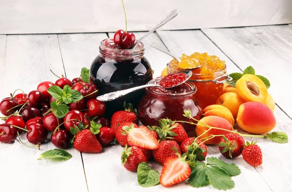 Auswahl an Marmeladen, saisonalen Beeren, Aprikosen, Minze und Früchten. — Stockfoto