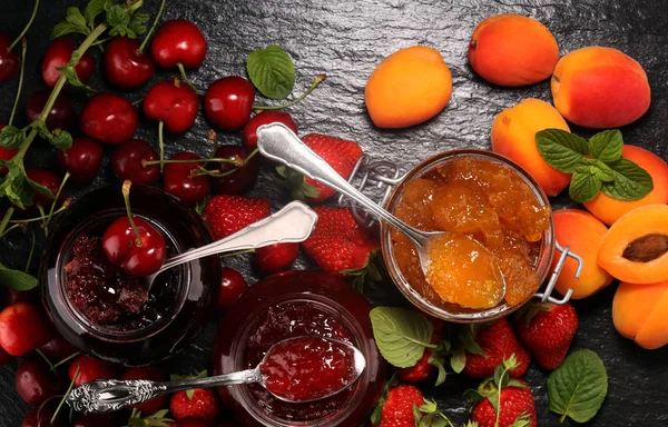 Assortment of jams, seasonal berries, apricot, mint and fruits. — Stock Photo, Image