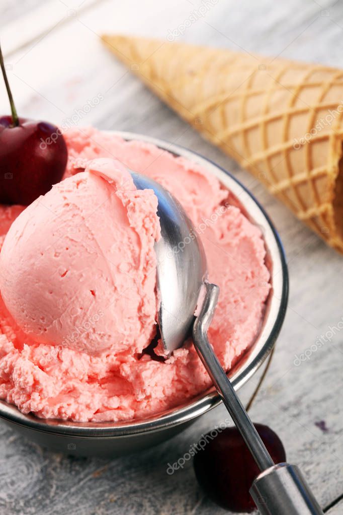 Cherry and vanilla ice cream scoop with fresh cherries and mint 