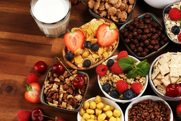 Cereal. Bowls of various cereals, berries and milk for breakfast