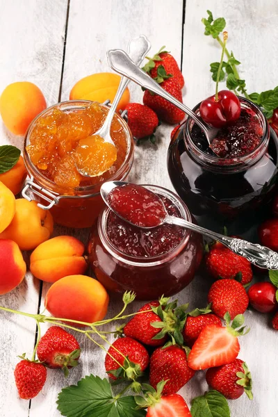 Assortment of jams, seasonal berries, apricot, mint and fruits. — Stock Photo, Image