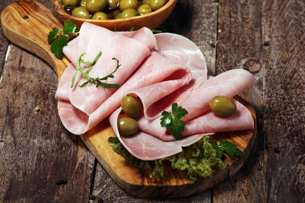 Sliced ham on wooden background. Fresh prosciutto. Pork ham pros