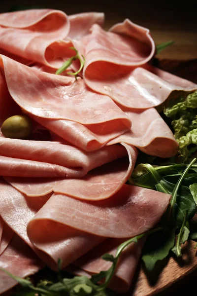 Sliced ham on wooden background. Fresh prosciutto. Pork ham pros