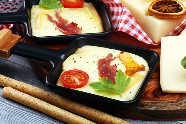 Delicious traditional Swiss melted raclette cheese on diced boil