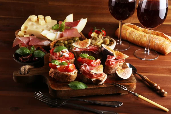 Tasty savory tomato Italian appetizers and bread with coppa and — Stock Photo, Image