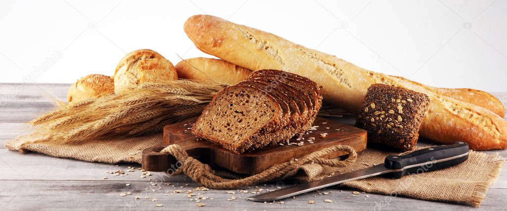 freshly baked bread on wooden board. cutted organic bread