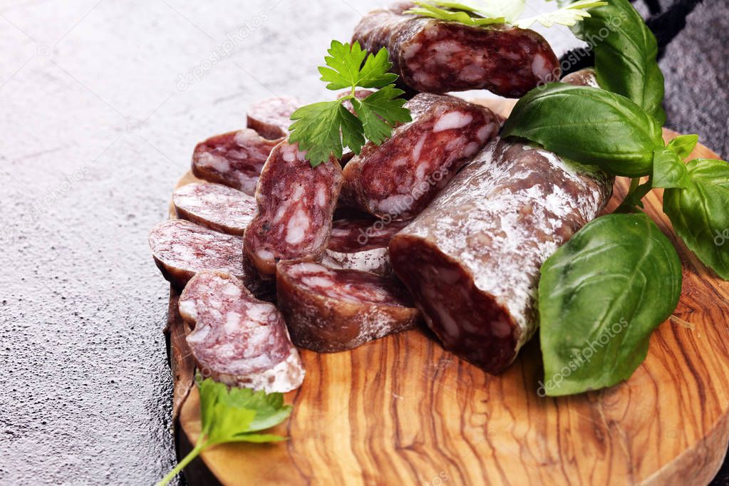 salami cut. thinly sliced salami on a wooden texture on the back