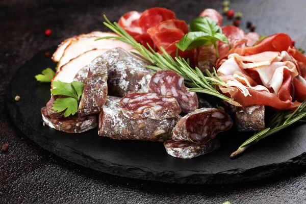 Marble cutting board with prosciutto, bacon, salami and sausages — Stock Photo, Image