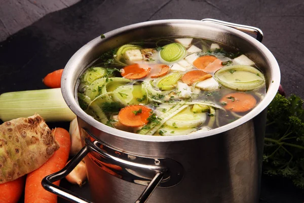 Broth with carrots, onions various fresh vegetables in a pot - c — Stock Image Broth with carrots, onions various fresh vegetables in a pot - c Stock Image