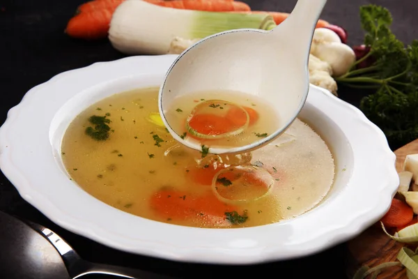 Broth with carrots, onions various fresh vegetables in a pot - c — Stock Photo, Image