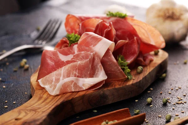 Food tray with delicious salami, coppa, crudo and herbs. Meat pl — ストック写真