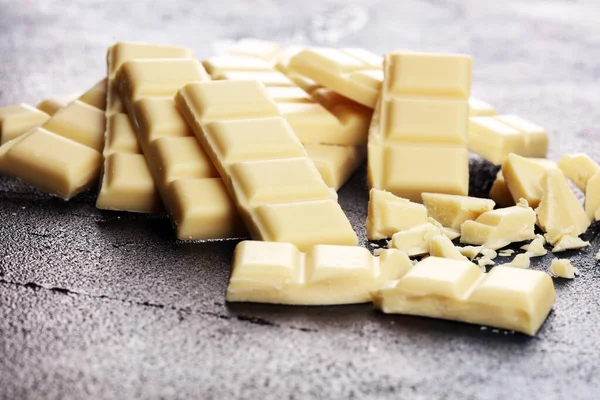 white broken chocolate and cocoa bar. Pieces of white chocolate