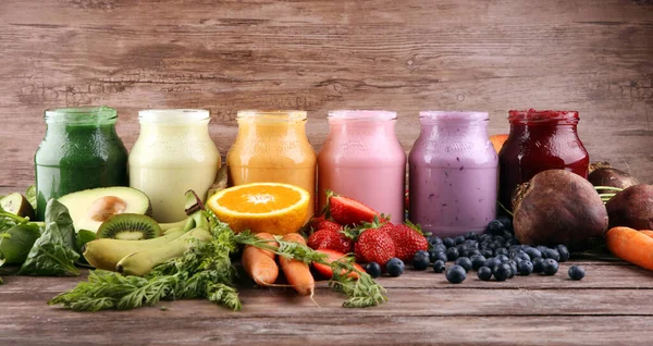 Multicolored smoothies and juices from vegetables, greens, fruits and berries, healthy food background. Detox and dieting, clean eating, healthy lifestyle concept