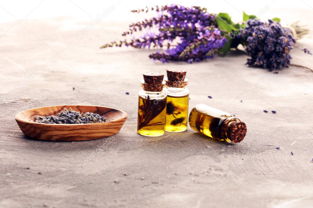 lavender herbal oil and lavender flowers. bottle of lavender massage oil for aromatherapy beauty treatment