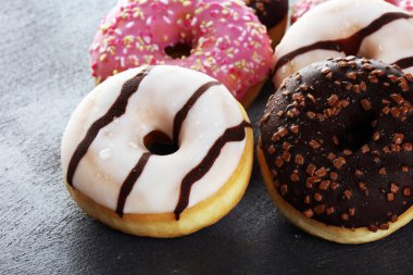 Çikolatalı donutlar, pembe jöleli ve şekerli çörekler..