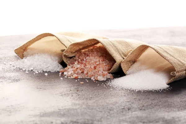 Sea salt and himalayan salt. Crystals of salt on rustic table