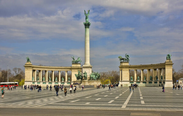 people walking at square of heroes, monument with cloudy sky, Budapest, Hungary