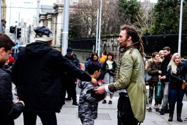 Dublin Ireland, February 21 2018: Editorial photo of a man collecting tips after a street performance. Important for Irish tourism