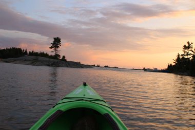 Gün batımında Kano kürek çekmek, güzel Georgan körfezi sularında kano