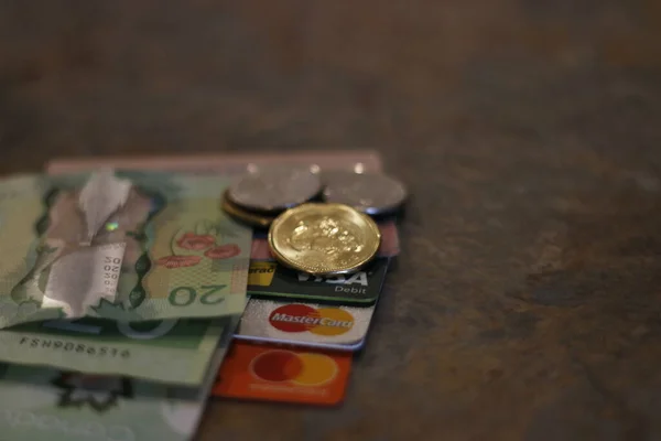 London Canada, December 25 2019: Editorial image of Canadian currency and credit cards. Theme of debt and spending.