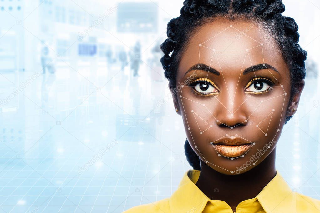 portrait of attractive african woman with facial recognition technology on airport background