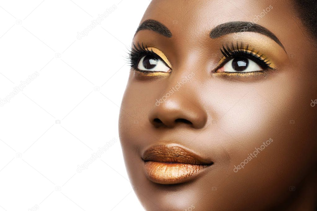 close-up cosmetic beauty portrait of young african american woman with professional make up isolated on white background