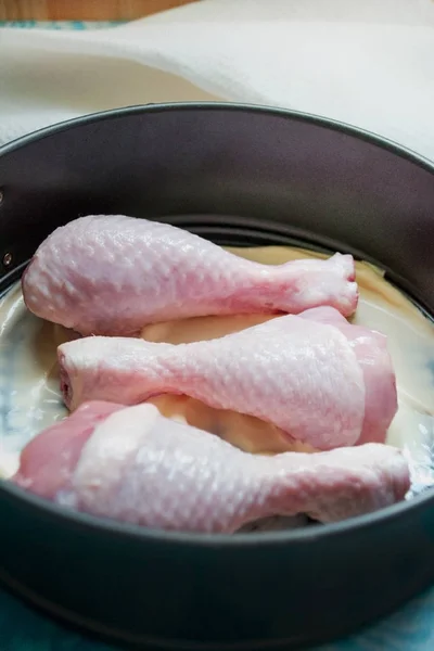 raw chicken legs in a baking dish