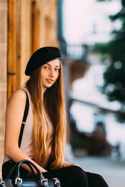 Wonderful Girl Long Hair Sitting Looks Camera Lens Blurred Background — Stock Photo, Image
