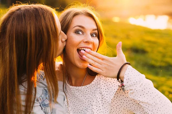 Girl Covers Mouth Hand Looks Surprised Camera Lens While Another — Stock Photo, Image