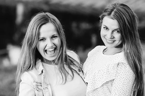 güzel kızlar kamera lense arıyoruz ve onlardan biri siyah ve beyaz fotoğraf üzerinde ağzını açtı