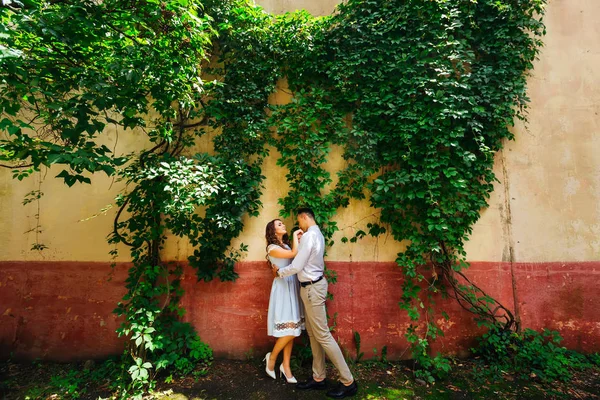 Guy Kisses Hand His Girlfriend Background Wall Grapes Green Foliage — Stock Photo, Image