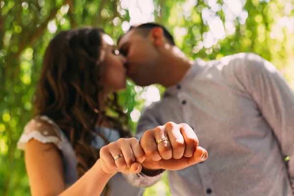 Foreground Hands Newlyweds Wedding Rings Background Newlyweds Kiss — Stock Photo, Image