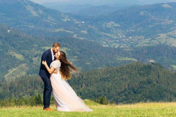 Embrace Newlyweds Top Mountain Backdrop Green Forests Mountains — Stock Photo, Image