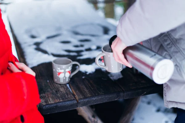 Wooden Table Partly Covered Snow Two Cups Guy Pours Them — Stock Photo, Image