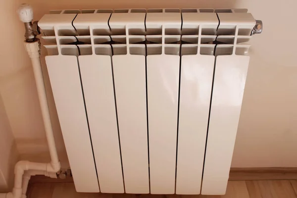 a close-up of a modern many sectional radiator that provides the circulation of warm air