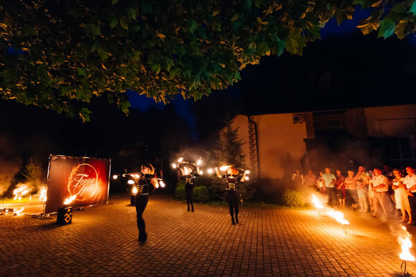 Morshyn, Ukraine - July 16, 2017 - A wonderful fire show for wedding guests in the yard of the restaurant