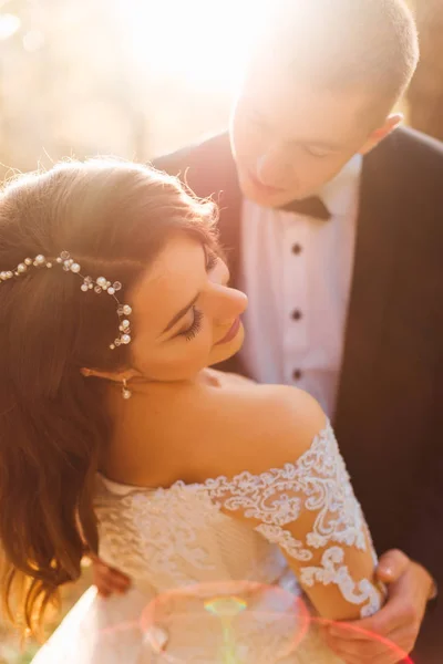 Наречений хоче поцілувати свою наречену. красива весільна сукня назад — стокове фото