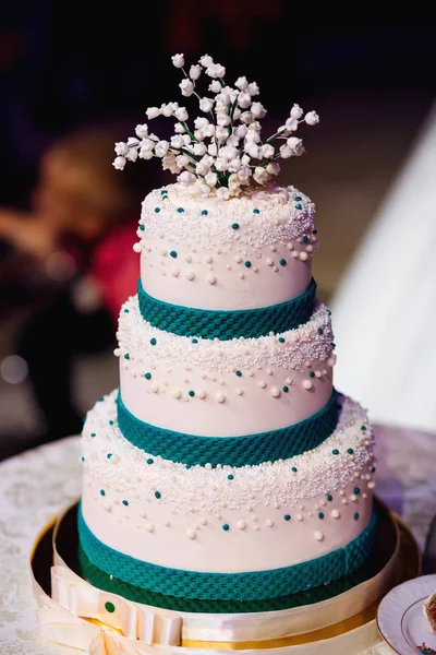 Beautiful wedding cake, decorated with lilies of the valley and