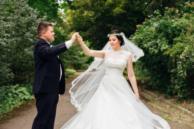 gelin parkta dans eder ve damat elini tutar