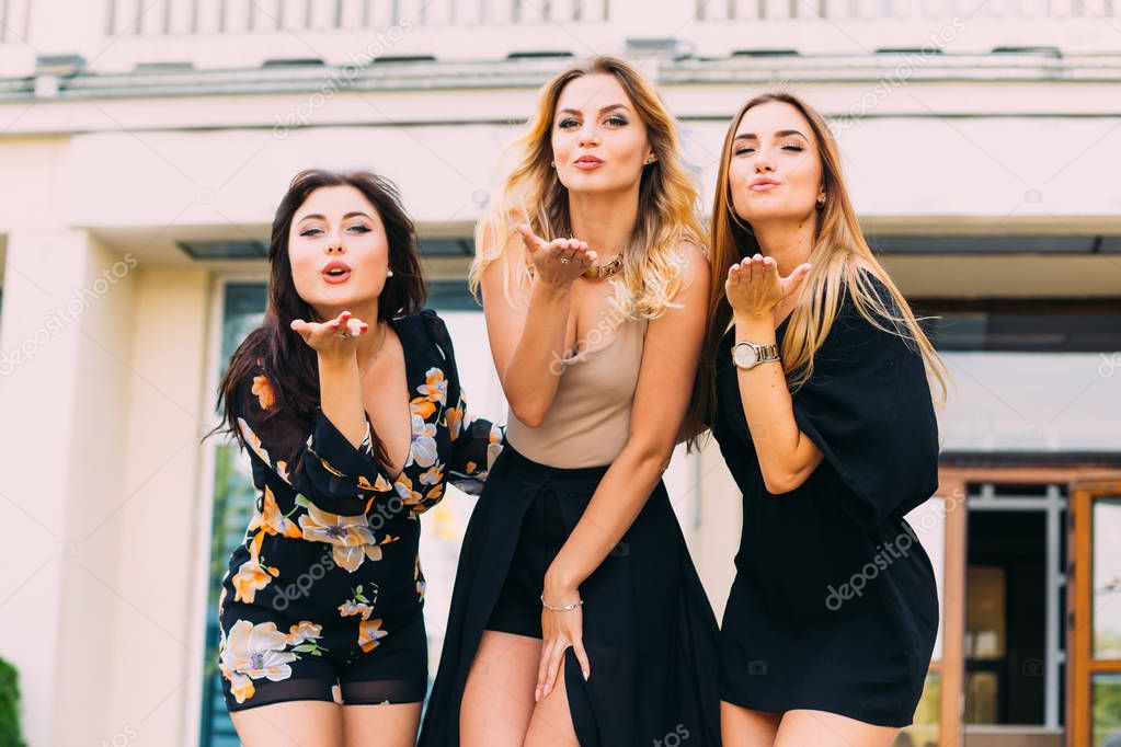 Portrait of group of gorgeous ladies sending kisses at camera. b