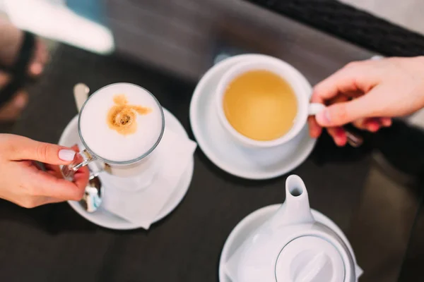 Кава і капучино на столі. рука жінки і чоловіка. кава — стокове фото