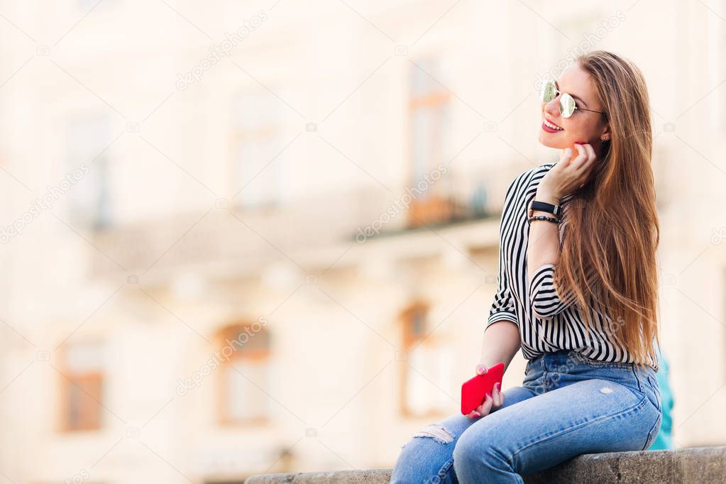 beautiful girl with long hair and sunglasses sitting on the back